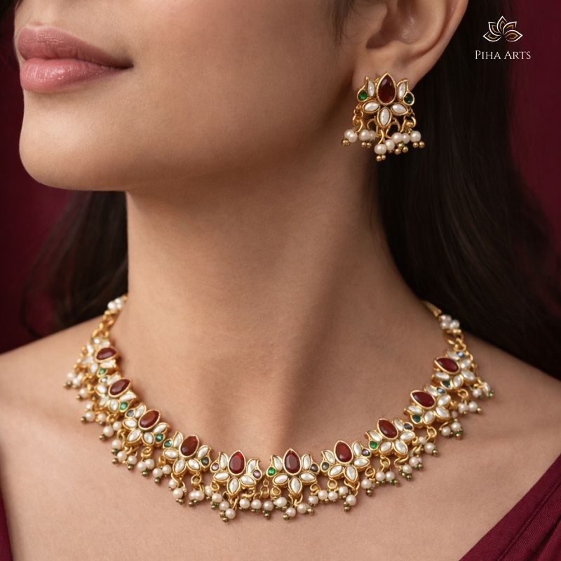 Gold Finish Kundan Necklace Set with Red & Green Stones and Pearl Earrings