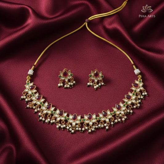 Gold Finish Kundan Necklace Set with Red & Green Stones and Pearl Earrings
